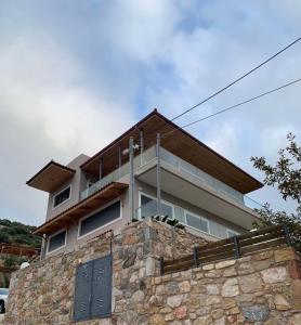 a house on top of a stone wall at Villa Katerina in Kalívia Thorikoú