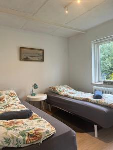 a bedroom with two beds and a window at nordic and retro apartment North of Cph 