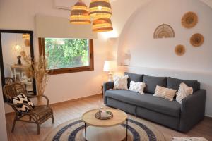 a living room with a blue couch and a table at Patmos Little Suites in Skala
