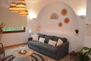 a living room with a couch and a table at Patmos Little Suites in Skala