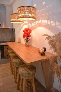 a kitchen with a wooden table with a vase of flowers at Patmos Little Suites in Skala
