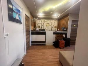 a hallway leading to a kitchen with a counter top at Hotel Avenue Suites Near International Airport Bangalore in Bangalore