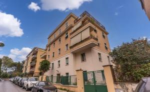 a large building with cars parked in front of it at PMT Apt in Rome