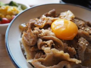 a bowl of food with an egg on top at Hotel Alpha-One Tokuyama in Shunan