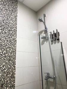 a shower with a glass door in a bathroom at Lux High Rise Marina Apartment in Dubai