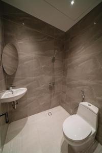 a bathroom with a toilet and a sink at The Nguyens - Pink Church View in Ho Chi Minh City