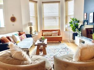 a living room with two couches and a table at Stunning 2 Bed Apartment Sea Views and Parking in Worthing