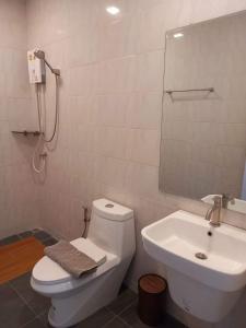 a bathroom with a white toilet and a sink at Koh Kood Club in Ko Kood