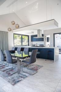 a kitchen and dining room with a table and chairs at Miles End Pezula in Knysna