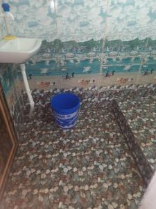 a bathroom with a sink and a mosaic floor at PALASH Pahar Resort in Jhalida