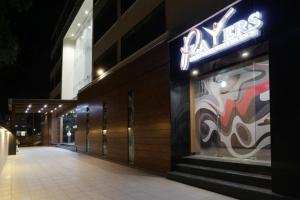 a building with a neon sign on the side of it at Grand Kailash Hotel in Aurangabad