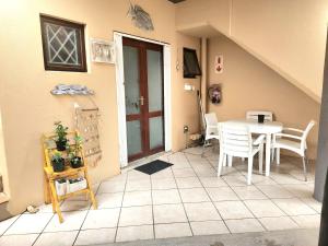 a dining room with a table and chairs in a room at Uvongo Sea Scapes Holiday Apartment in Margate