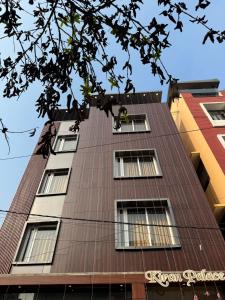 a tall building with windows on the side of it at Kiran Palace in Varanasi