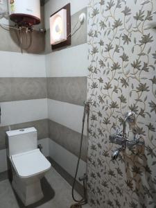 a bathroom with a toilet and a shower at KASHI DARSHAN in Varanasi