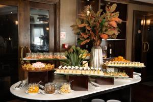 a buffet with many different types of desserts on display at AMBASSADOR SIGNATURE CRUISE - Lan Ha Bay in Ha Long