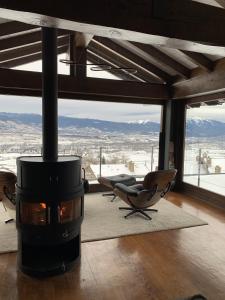 a fireplace in a room with chairs and a view at Mas Farner - Adults Only in Llivia