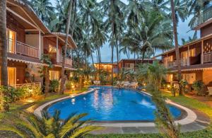 una imagen de una piscina en un complejo en Le dando Beach Resort by Orion Hotels en Old Goa