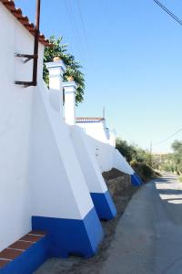 a row of blue and white stairs on a wall at Casa do Forte Elvas in Elvas