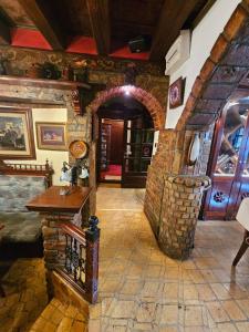 a living room with a stone wall and an archway at Vila Geppetto in Belgrade