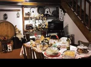 a dining room table with food and a bottle of wine at Litheon House in Synikia Mesi Trikalon