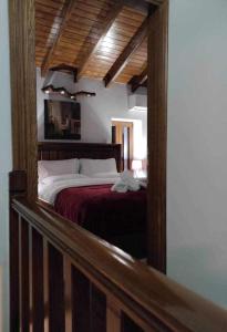 a bedroom with a bed with a red blanket at Litheon House in Synikia Mesi Trikalon