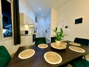 a dining room table with four plates on it at Luxury Suites Mons by Rikas Hotels in Mons