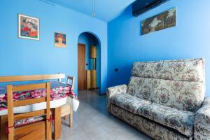 a living room with a couch and blue walls at Roomy Apartment with Balcony! in Milan