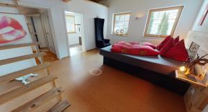 a bedroom with a bed with red pillows on it at Zillertal Residenz in Ginzling