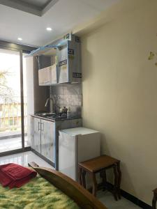 a kitchen with a refrigerator and a table in a room at Murree Oaks Tulip Block in Murree