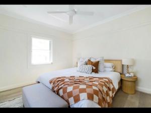 a white bedroom with a large bed and a window at Little Manly 3 bedroom Oasis in Sydney