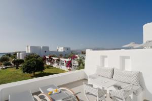 a balcony with a table and chairs and a view at White Dunes Luxury Boutique Hotel in Santa Maria