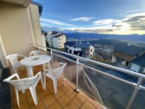 a balcony with a table and chairs and a view at Appartement Font-Romeu-Odeillo-Via, 3 pièces, 5 personnes - FR-1-758-18 in Font Romeu Odeillo Via