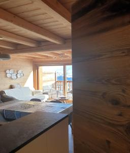 a room with two beds and a living room at LOdyssée 203 in La Toussuire