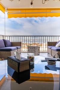 a living room with a couch and a table at Suite vue sur mer in Marseille