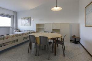 a room with a table and chairs and a bed at Residence Il Patriarca in Viareggio