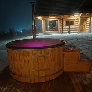 a wooden hot tub in front of a cabin at beskid.house1 in Spytkowice