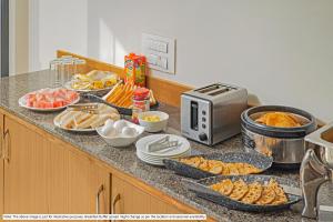 a kitchen counter with a buffet of food on it at Treebo Trend Raval Resort in Panchgani
