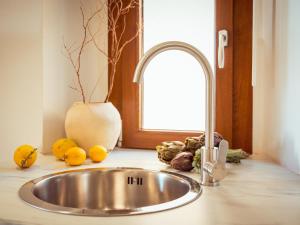 a sink in a kitchen with fruits and vegetables at Dea Little Suite in Palestrina +34 photos