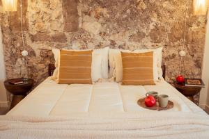 a white bed with a tray of fruit on it at Dea Little Suite in Palestrina
