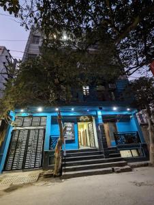a statue in front of a blue building with lights at Hotel Trendy residency in New Delhi