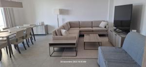 a living room with a couch and a table at Olympus Residence in Timişoara