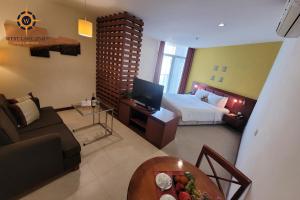 ein Schlafzimmer mit einem Bett, einem Sofa und einem Tisch in der Unterkunft West Lake 254D Hotel & Residence in Hanoi