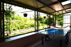 a greenhouse with a glass table in front of a window at La Casa di Mimma in Caposele