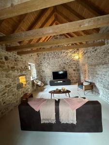 a living room with a couch and a table at Maison Laurel - Exquisitely Renovated Centuries Old Stone Estate With Private Pool, Near Split and Omiš in Gata