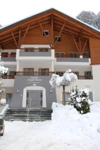 a large building with snow in front of it at Hotel Argentum by Bergkristall in Fleres