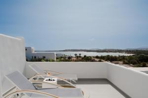 a balcony with chairs and a view of the water at White Dunes Luxury Boutique Hotel in Santa Maria