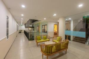 a hallway with two chairs and a table in a building at Đại Nam SG Hotel in Ho Chi Minh City