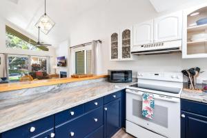 a kitchen with blue cabinets and a counter top at Big Island Waikoloa Hills 1304 condo in Waikoloa Village