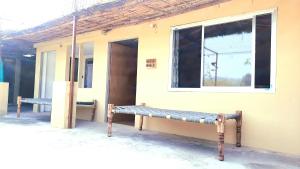 a bench sitting outside of a building with a window at Vedic Life Homestay & Wellness Centre in Jaipur