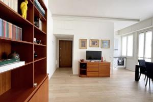 a living room with a tv and a desk with a computer at Charlotte House City Center in Milan